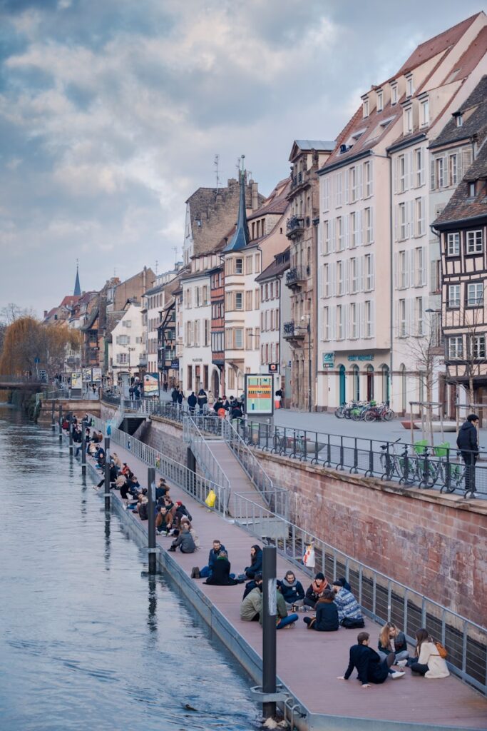 people on river between buildings during daytime